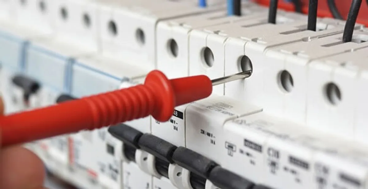 Electrical contractor testing circuit breakers during electrical repair in Windsor Heights, IA