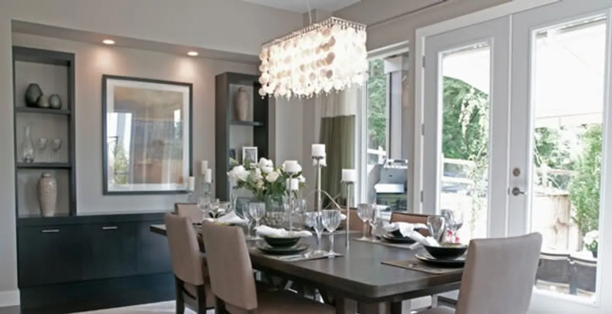 Elegant dining room chandelier installation above table in Des Moines, IA