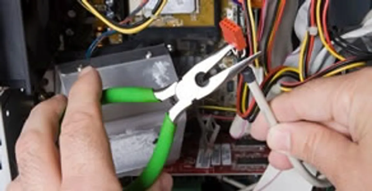 Licensed electrical contractor performing electrical repair with tools in Urbandale, IA