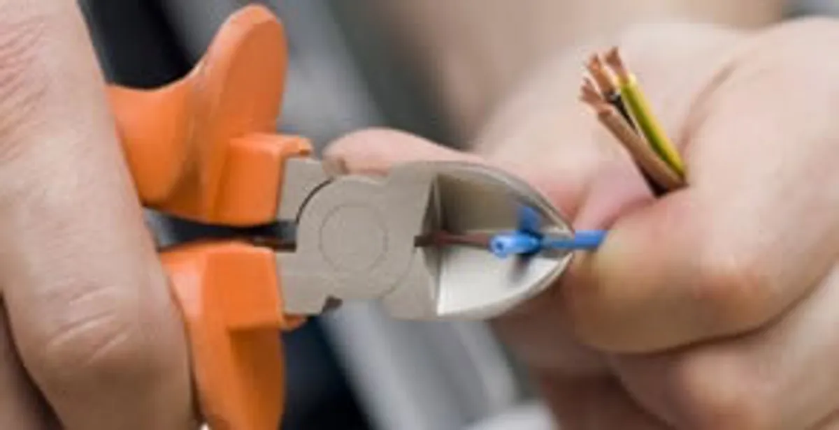 professional electrical services showing precise wire cutting by licensed electricians in Des Moines, IA