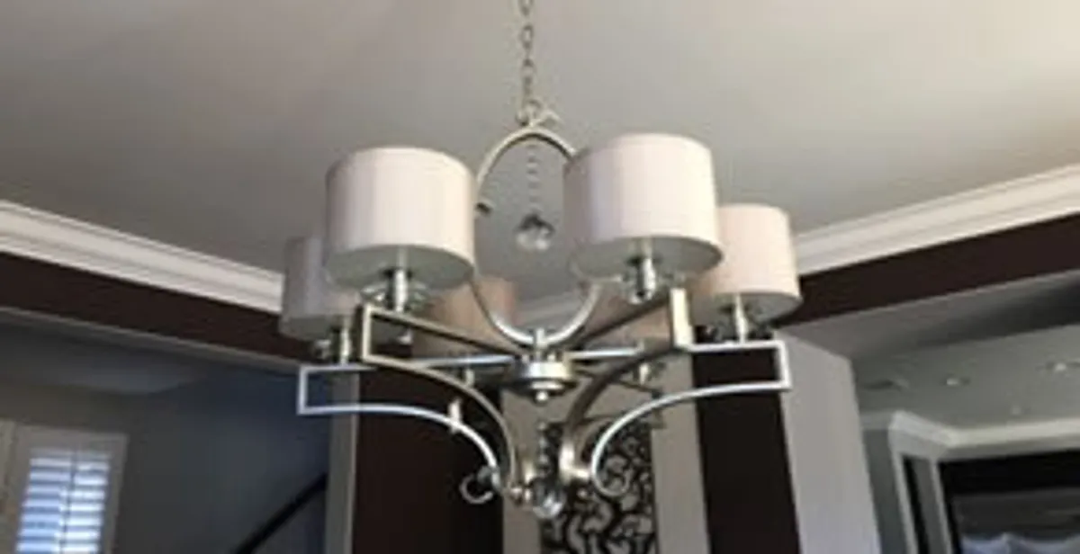 Modern chandelier installation with multiple light fixtures in Des Moines, IA